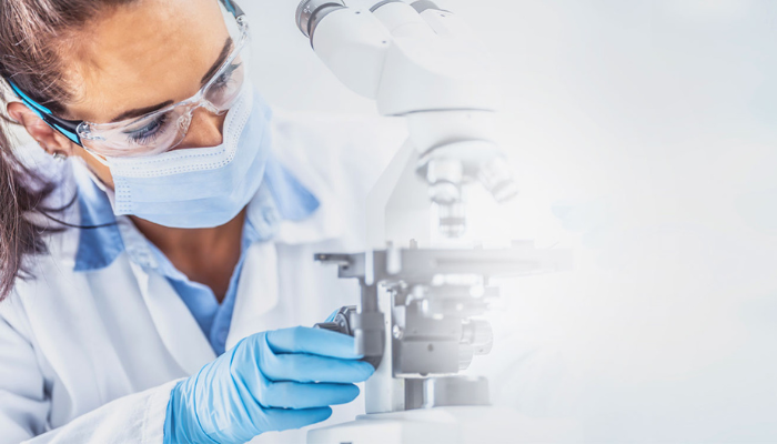 Scientist at Microscope - 700x400